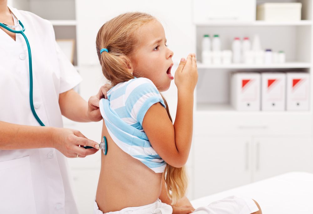Doctor checks patient for whooping cough prevention.