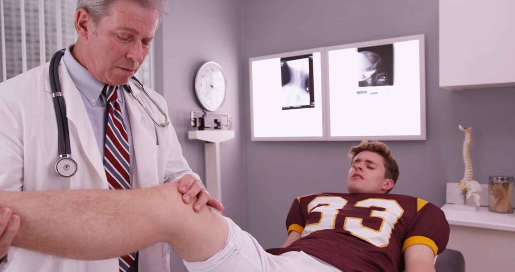 Physician treating sports injury